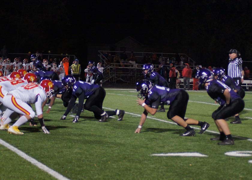 The Pirates prepare to block Atchison from charging down the field.