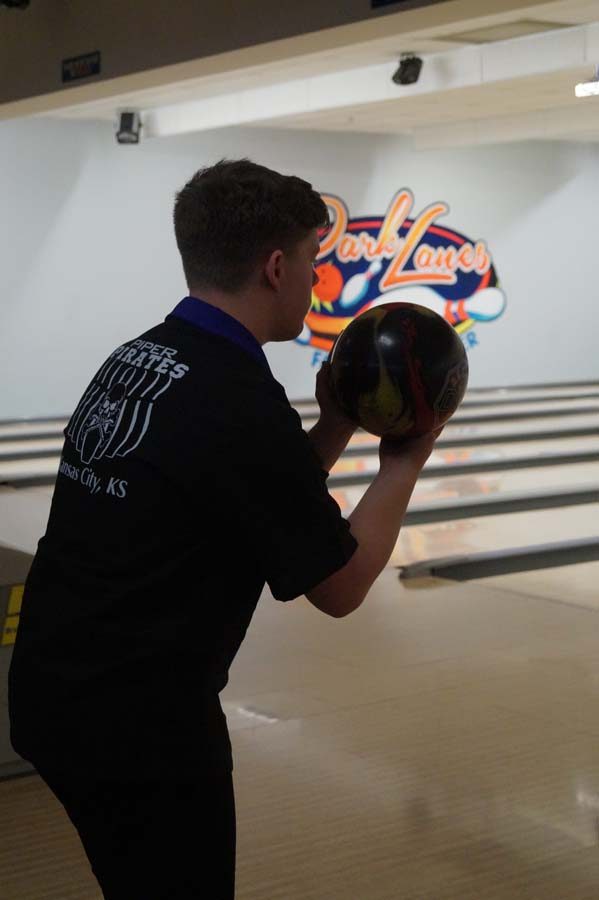 Sophomore Benn Brandt lines up the shot at regionals for one of the last frames in his individual game Feb. 23.