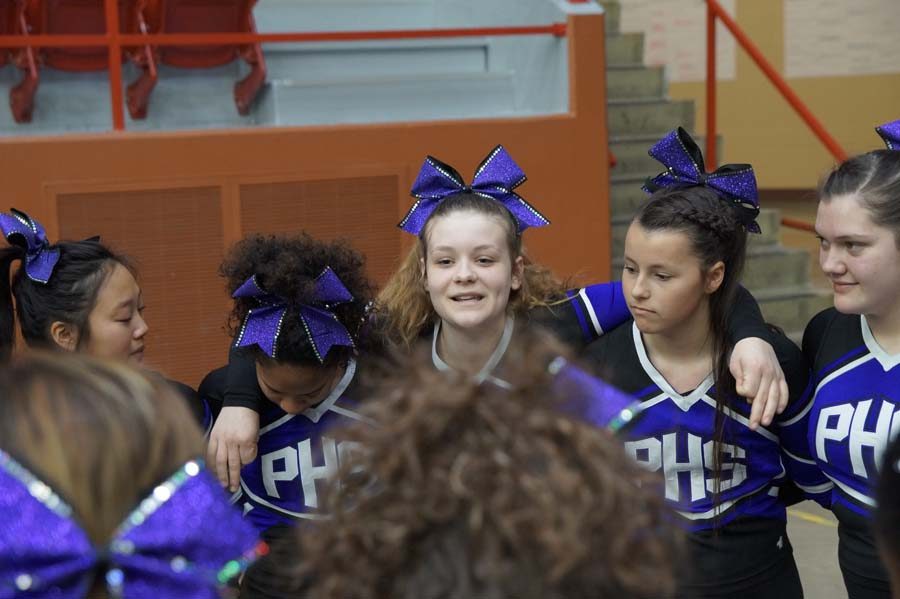 Junior co-captain Emma Johnson leads the cheer team in a pre-game pep talk. The final state basketball game was the final time the team would cheer this year.