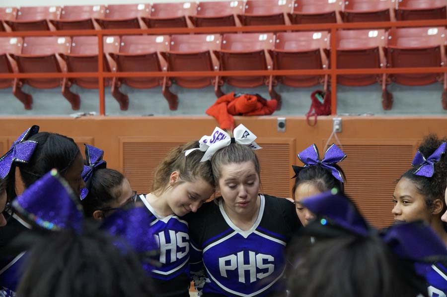 Seniors Grace Vogel and Sophia Frick participate in their last time cheering with all of their friends on the squad. Vogel got emotional saying goodbye to her cheer team and co-captain Emma Johnson.