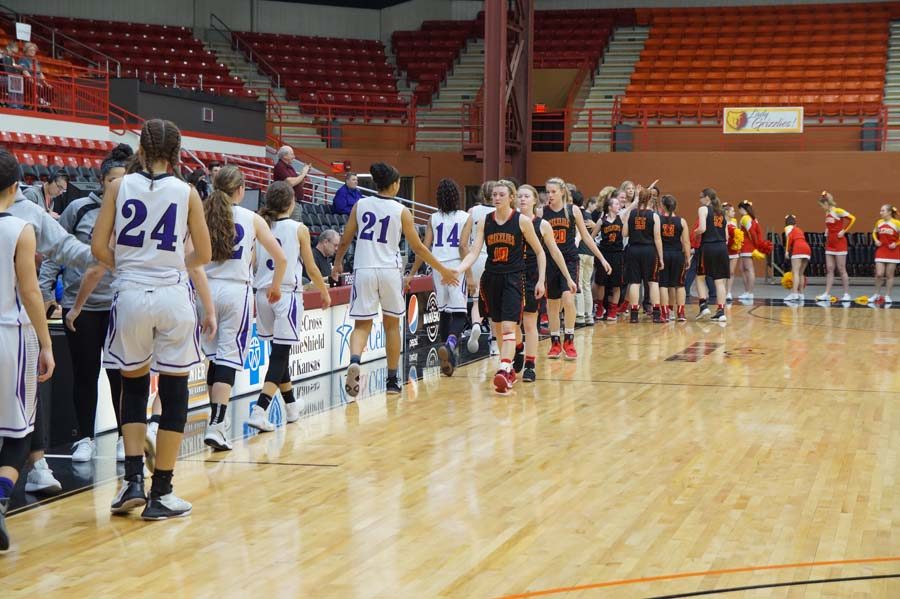 The teams line up to shake hands after the Pirates win, 68-48.