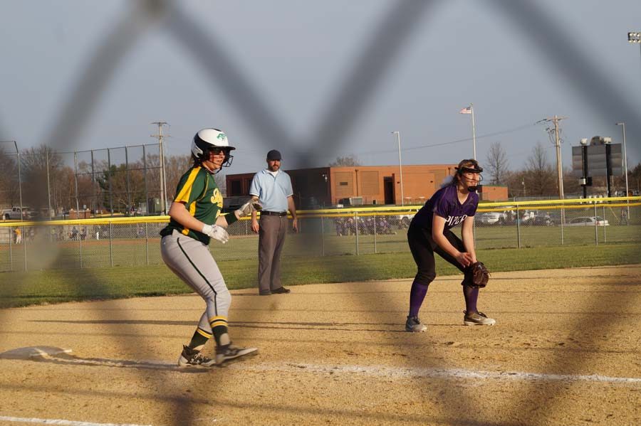 Payton Fergus stands her ground for third base while the runner waits on the hit to score.