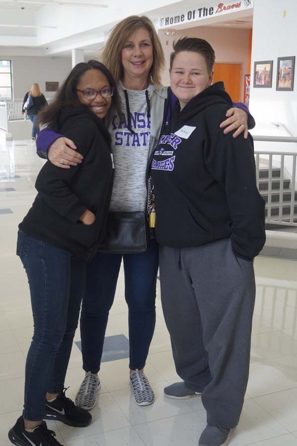 Retired teacher Ann Hamilton runs into her old students Maya and Natalie Masters. They talk for a few minutes before getting to work volunteering.