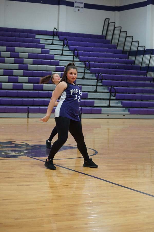 Junior Taylor McEachron stares at the crowd as she performs a hip hop routine. 