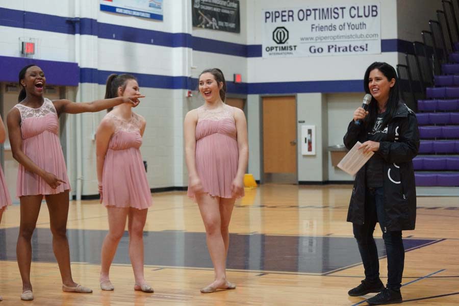 Seniors Isley Ford, Aubree Knetter and Hannah Haworth laugh as coach Christine Kohrs makes a joke. 