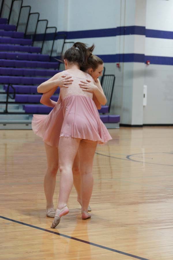 Senior Aubree Knetter and sophomore Morgan Haworth hug during their final dance. 