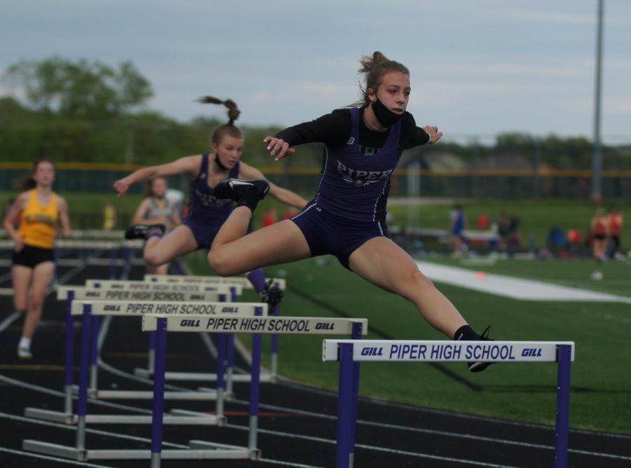 Freshman Genevieve Kulas run the 300 meter hurdles Wednesday, May 5 at the Piper High School Invitational track meet. Kulas, new to the 300 meter hurdles, placed 2rd overall.