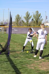 Freshmen Ryleigh Vinyard and Brooklyn Dissmeyer warm up together before the first game.